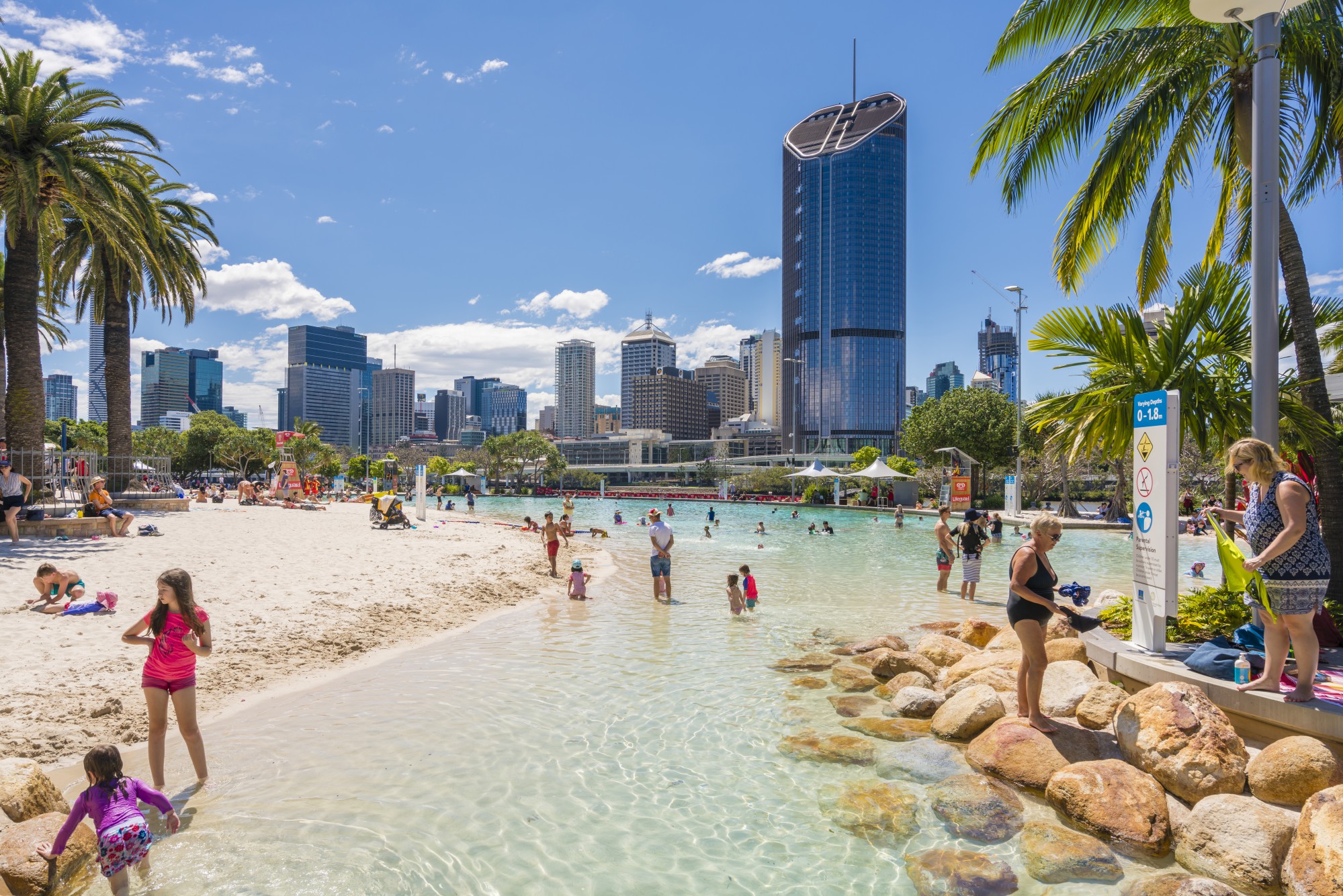The Streets Beach on a busy day, with Brisbane city in the background