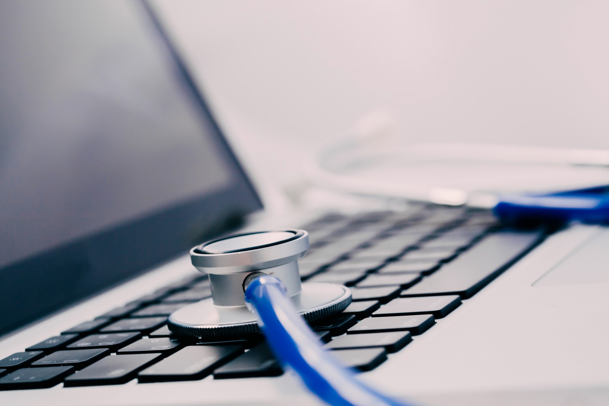 A stethoscope placed on top of a laptop