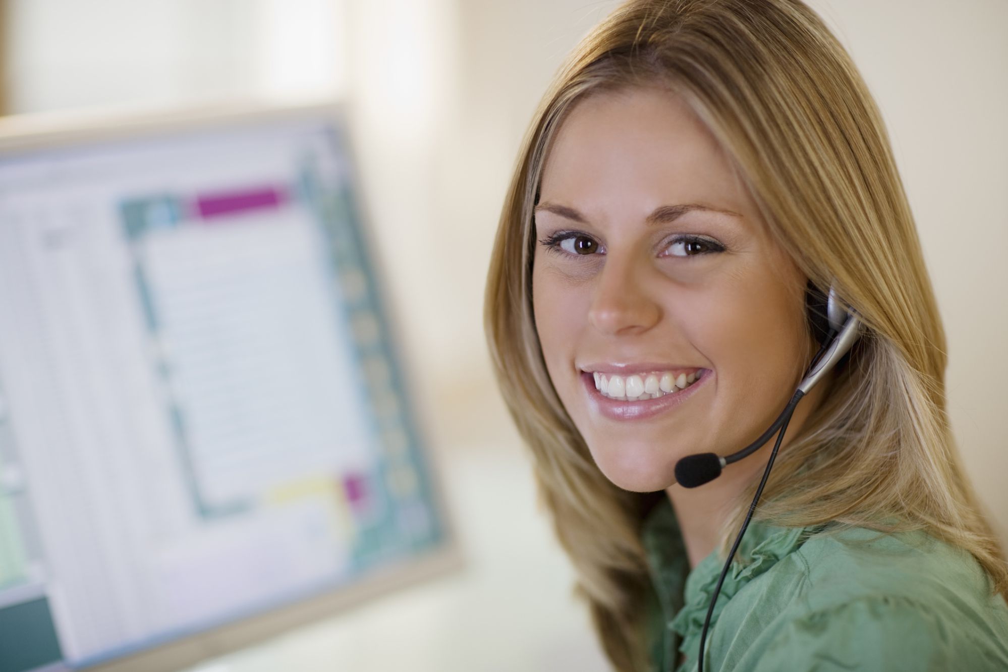 A female receptionist smiling at the camera