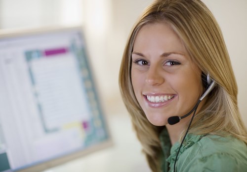A female receptionist smiling at the camera