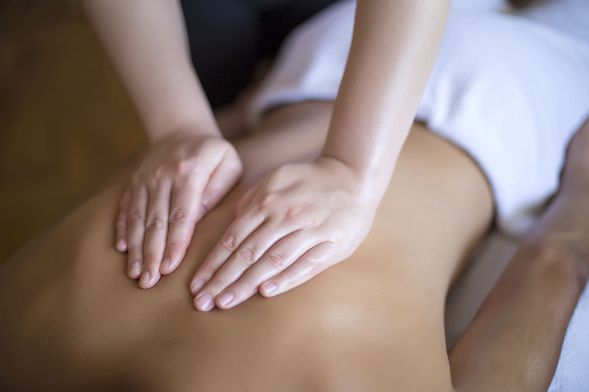 A female osteopath massaging a patient