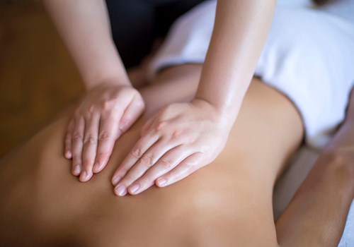 A female osteopath massaging a patient