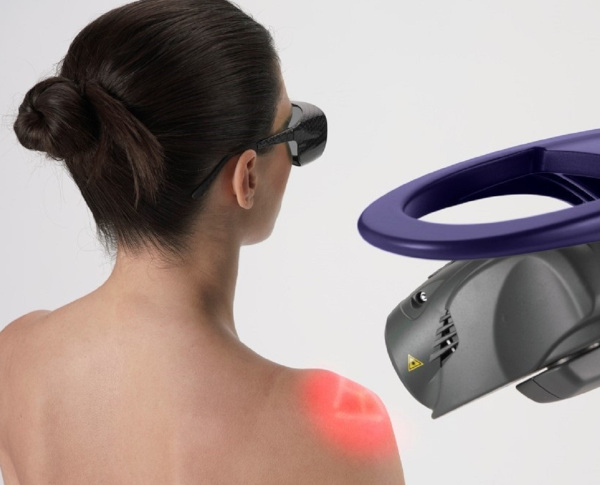 A woman undergoing laser therapy while wearing protective glasses