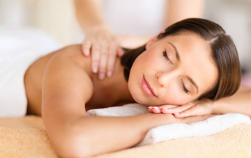 A woman lying chest down enjoying a massage 